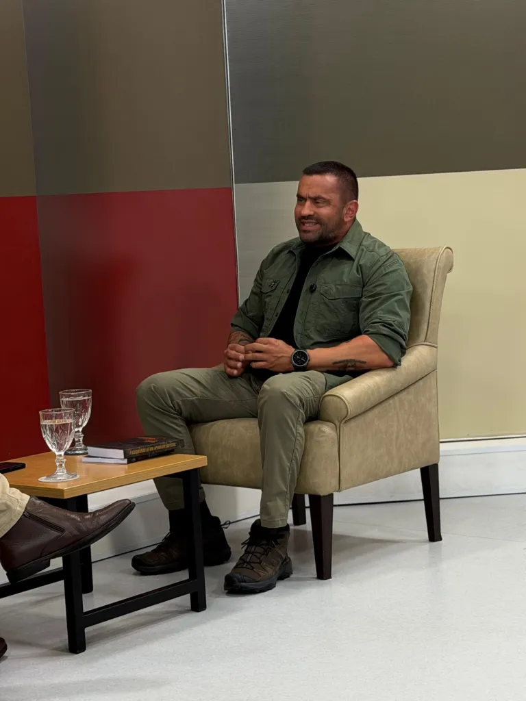Douglas Pithon sentado em estúdio durante entrevista